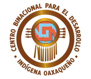 Logo with text Centro Binacional para el Desarrollo Indígena Oaxaqueño encircling a circular emblem featuring Indigenous patterns, arrows, and hanging decorations, evoking cultural heritage and collaboration.